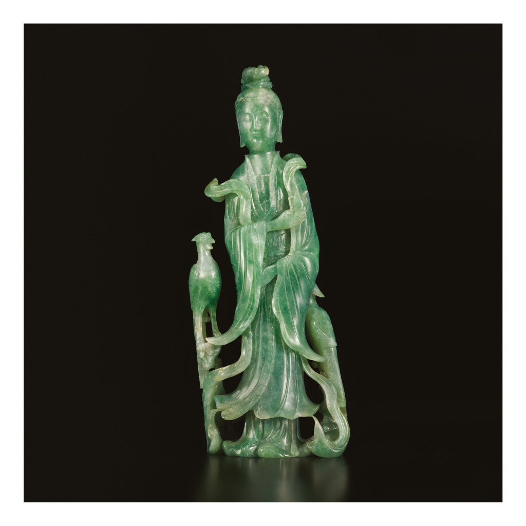 View full screen - View 1 of Lot 672. AN APPLE-GREEN JADEITE FIGURE OF A STANDING MEIREN, LATE QING DYNASTY.