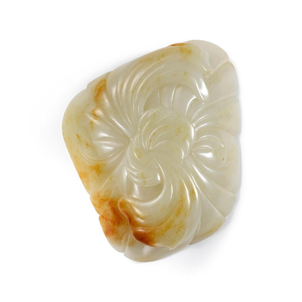 View full screen - View 1 of Lot 1015. A pale celadon and russet jade ribbon-form ink palette, Qing dynasty, 18th / 19th century | 清十八 / 十九世紀 青白玉雕包袱紋筆掭.