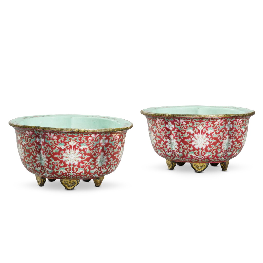 View full screen - View 1 of Lot 84. A pair of ruby-ground famille-rose jardinières, Qing dynasty, 19th century | 清十九世紀 胭脂紅地粉彩纏枝蓮紋梅式花盆一對 《大清乾隆年製》仿款.