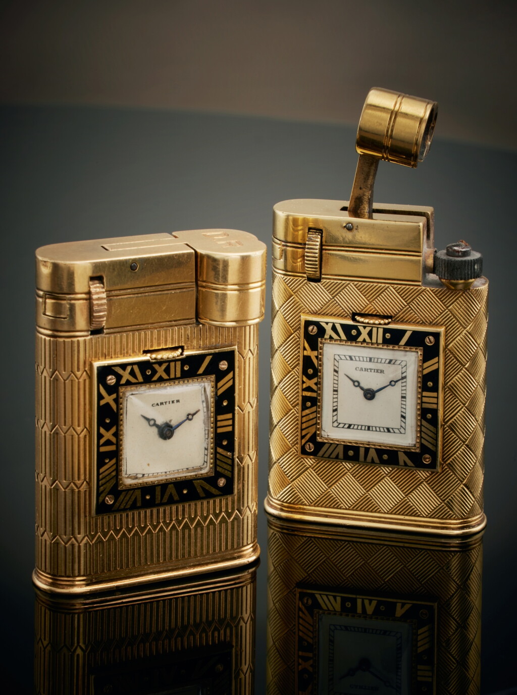 View full screen - View 1 of Lot 222. Two yellow gold and enamel lighters with timepiece, Circa 1930.