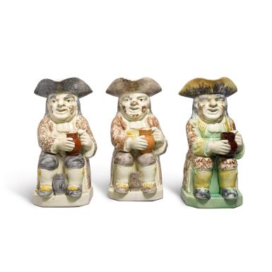 View full screen - View 1 of Lot 64. Three Staffordshire creamware Toby jugs, circa 1785.