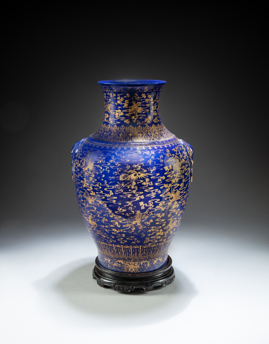 View full screen - View 1 of Lot 142. A gilt-decorated blue-ground 'phoenix and clouds' vase, Qing dynasty, 19th century | 清十九世紀 霽藍地描金雲鳳紋瓶《大清乾隆年製》仿款.