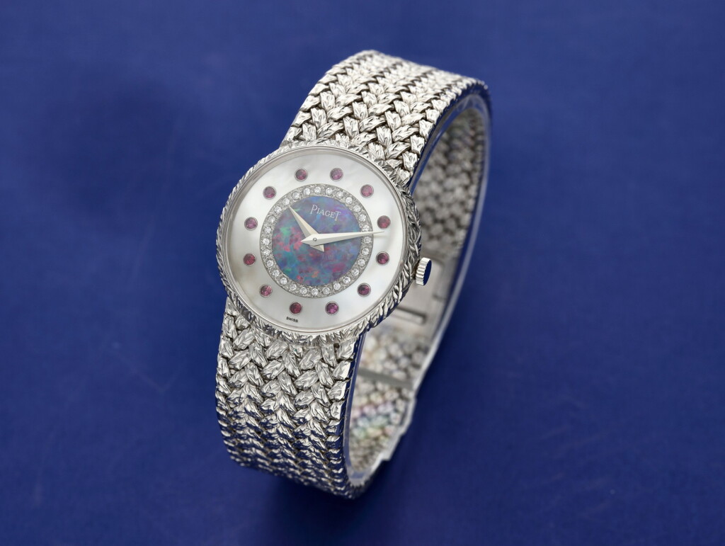 View full screen - View 1 of Lot 109. Reference 9005 D 2 A white gold, mother-of-pearl, opal, diamond and ruby-set bracelet watch, Circa 1975.