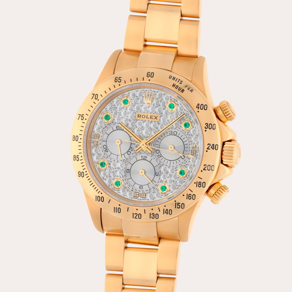 View full screen - View 1 of Lot 121. Daytona 'Zenith', Reference 16528 | A yellow gold chronograph wristwatch with bracelet and diamond and emerald-set dial | Circa 1994.