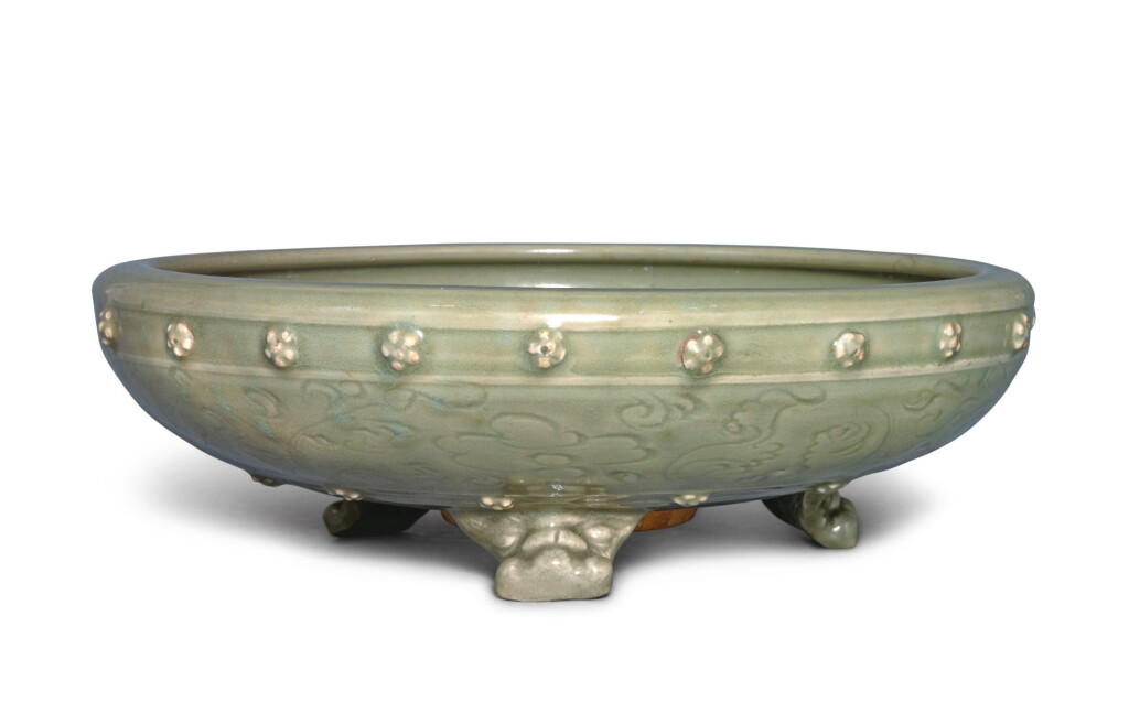 View full screen - View 1 of Lot 124. A carved celadon-glazed 'Longquan' tripod bulb bowl, Ming dynasty | 明 龍泉窰青釉刻花乳釘紋三足洗.