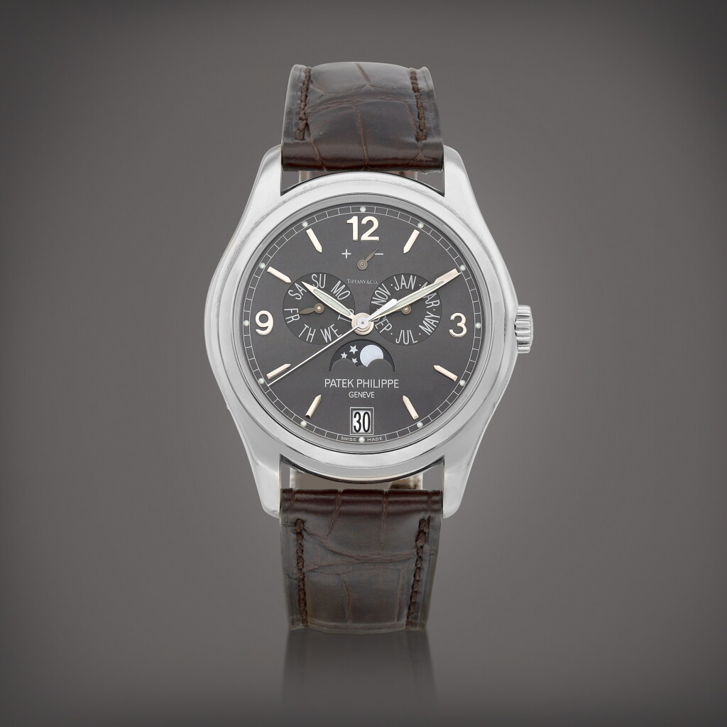 View full screen - View 1 of Lot 711. Reference 5146 | A white gold annual calendar wristwatch with moon phases and power reserve indication, Retailed by Tiffany & Co., Circa 2014 | 百達翡麗 | 型號5146 | 白金年曆腕錶,備月相及動力儲備顯示,由 Tiffany & Co. 發行,約2014年製.