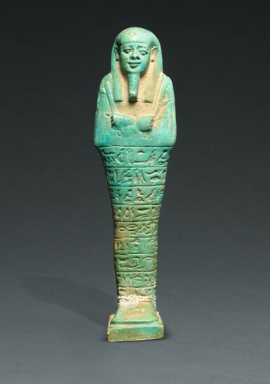 View full screen - View 1 of Lot 68. AN EGYPTIAN TURQUOISE FAIENCE USHABTI OF TJAI-NE-HEBU, ADMIRAL OF THE ROYAL FLEET, 26TH DYNASTY, REIGN OF AMASIS, 570-526 B.C..