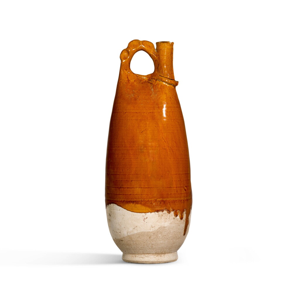 View full screen - View 1 of Lot 358. A LARGE AMBER-GLAZED FLASK, LIAO DYNASTY, 11TH CENTURY | 遼 十一世紀 黃釉鷄冠壺.