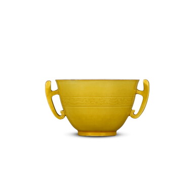 View full screen - View 1 of Lot 3. A yellow-glazed handled cup, Qing dynasty, 18th century | 清十八世紀 黃釉暗刻龍紋耳盃.