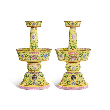 View full screen - View 1 of Lot 31. A rare pair of yellow-ground famille-rose candlesticks, Seal marks and period of Qianlong | 清乾隆 粉彩黃地纏枝蓮紋八吉祥燭臺一對 《大清乾隆年製》款.