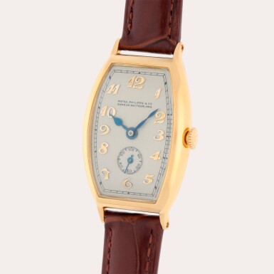 View full screen - View 1 of Lot 299. A yellow gold tonneau shaped wristwatch with Breguet numerals dial | Made in 1929.