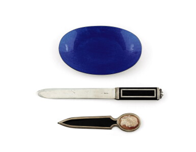 View full screen - View 1 of Lot 270. A group of a blue enamelled silver desk oval bowl, a silver and ebony paperknife and an enamelled paperknife mounted with a cameo | Groupe comprenant un vide-poche en argent émaillé bleu, un coupe-papier en argent et ébène et un coupe-papier en émail serti d'un camée.