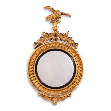 View full screen - View 1 of Lot 592. A REGENCY GILT AND EBONIZED WOOD CONVEX MIRROR, EARLY 19TH CENTURY.