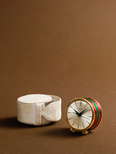 View full screen - View 1 of Lot 2137. A gilt-brass and enamel miniature travelling drum-form musical alarm clock, Circa 1960s.