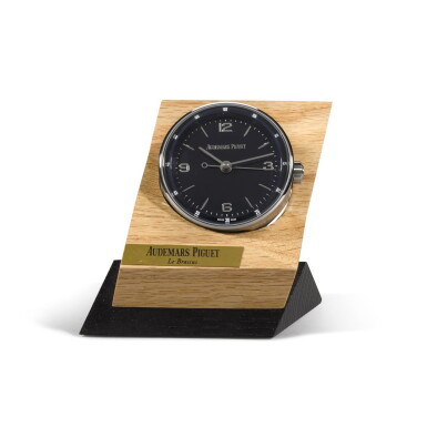 View full screen - View 1 of Lot 724. STAINLESS STEEL DESK TIMEPIECE WITH ALARM AND WOODEN STAND CIRCA 2015.