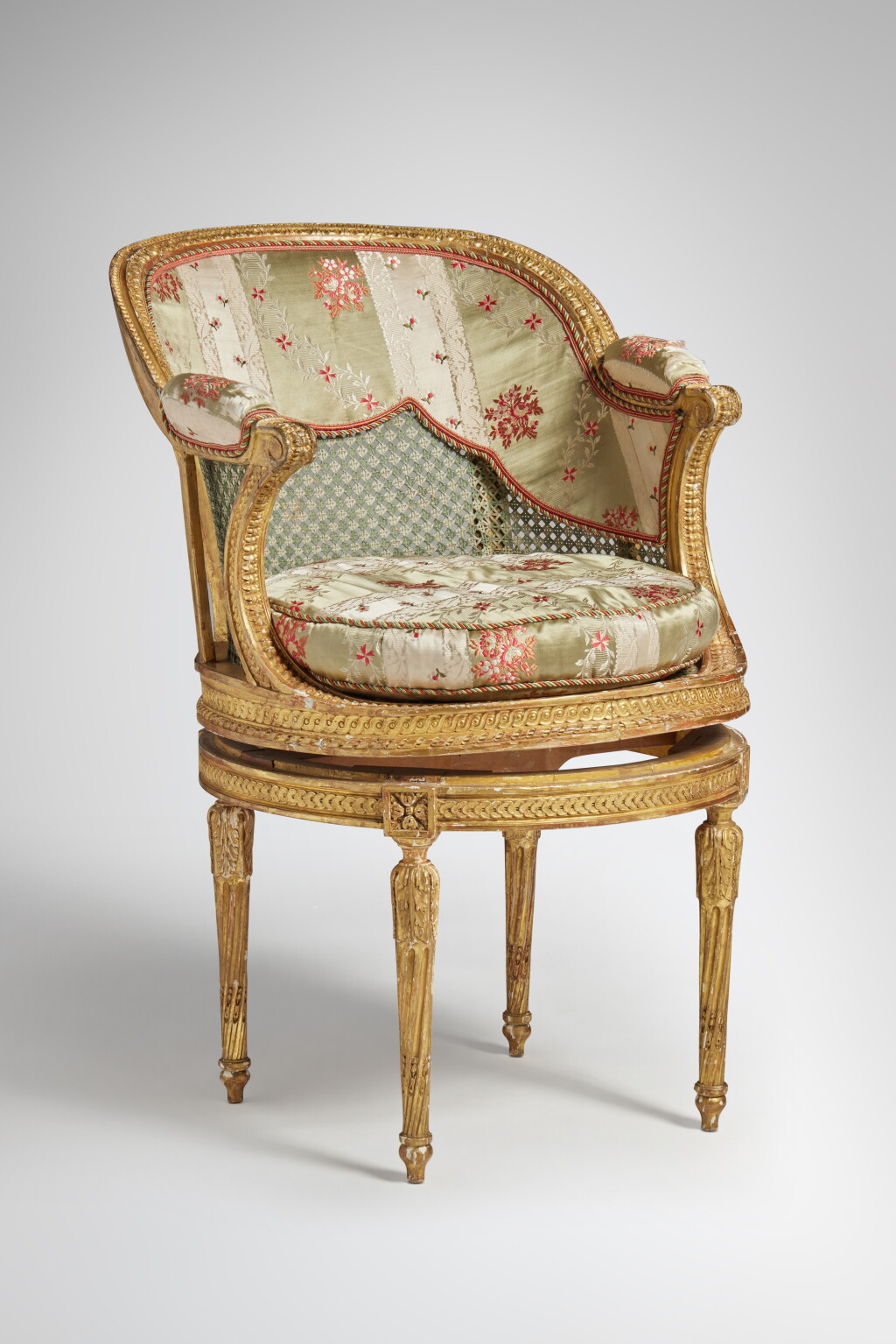 View full screen - View 1 of Lot 116. A Louis XVI Giltwood and Caned Fauteuil de Bureau in the manner of Georges Jacob, Circa 1780.