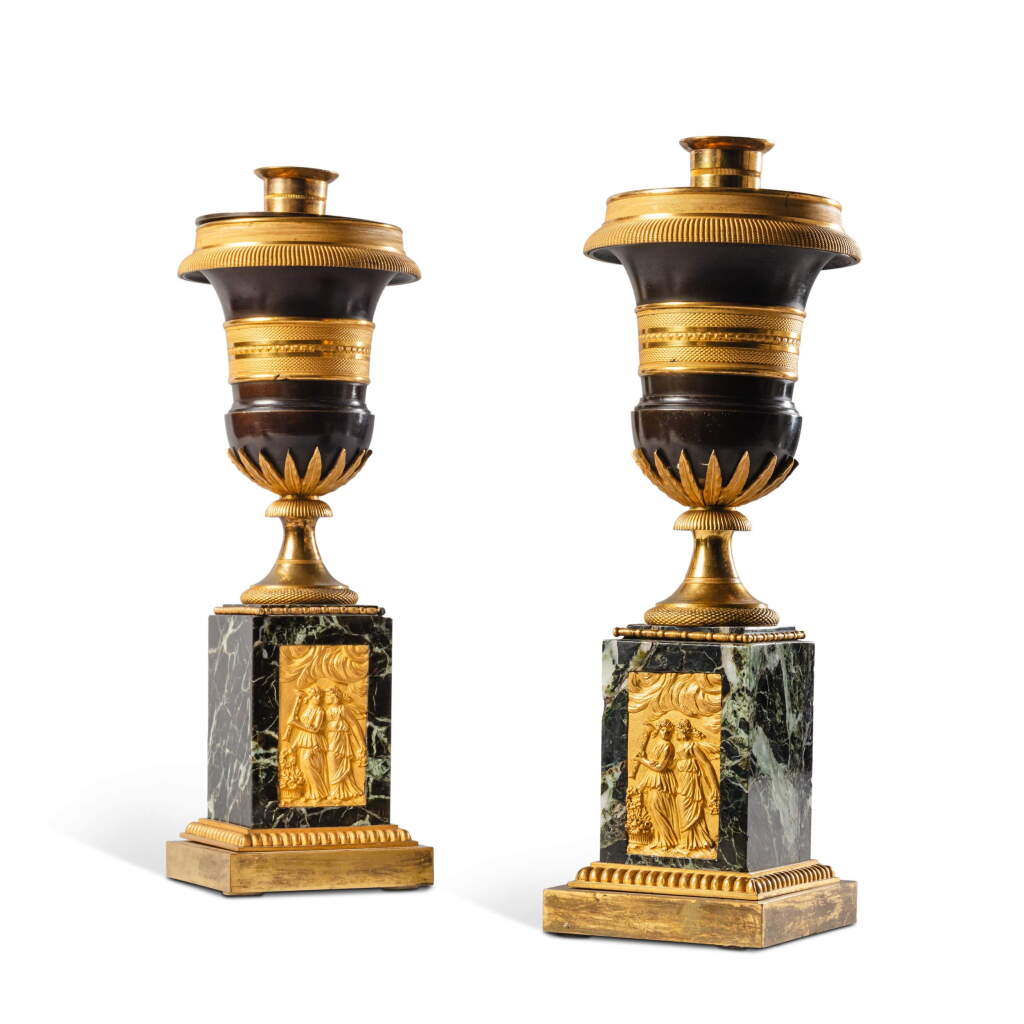 View full screen - View 1 of Lot 21. A pair of Empire style gilt and patinated bronze cassolettes forming canslesticks, late 19th century.