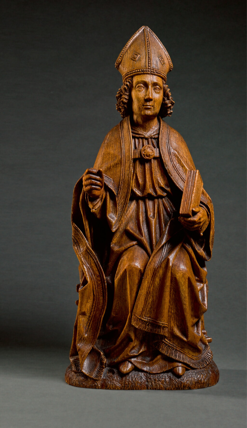 View full screen - View 1 of Lot 26. ATTRIBUTED TO TILMAN HEYSACKER, CALLED MEISTER TILMAN (ACTIVE CIRCA 1475-1515), GERMAN, COLOGNE, CIRCA 1500 | SEATED BISHOP SAINT.