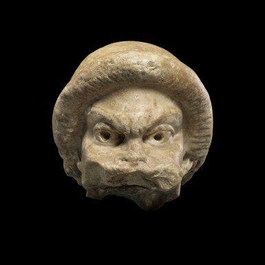 View full screen - View 1 of Lot 104. A Fragmentary Roman Marble Theater Mask, circa 2nd Century A.D..