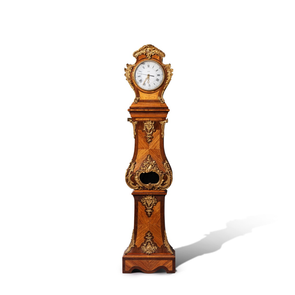 View full screen - View 1 of Lot 66. A Louis XV gilt-bronze mounted tulipwood and holly veneered longcase clock, the case stamped by Nicolas Petit, the dial signed Janvier.