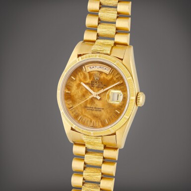 View full screen - View 1 of Lot 48. Day-Date, Reference 18248 A yellow gold wristwatch with day, date, burl wood dial and bracelet Circa 1979.