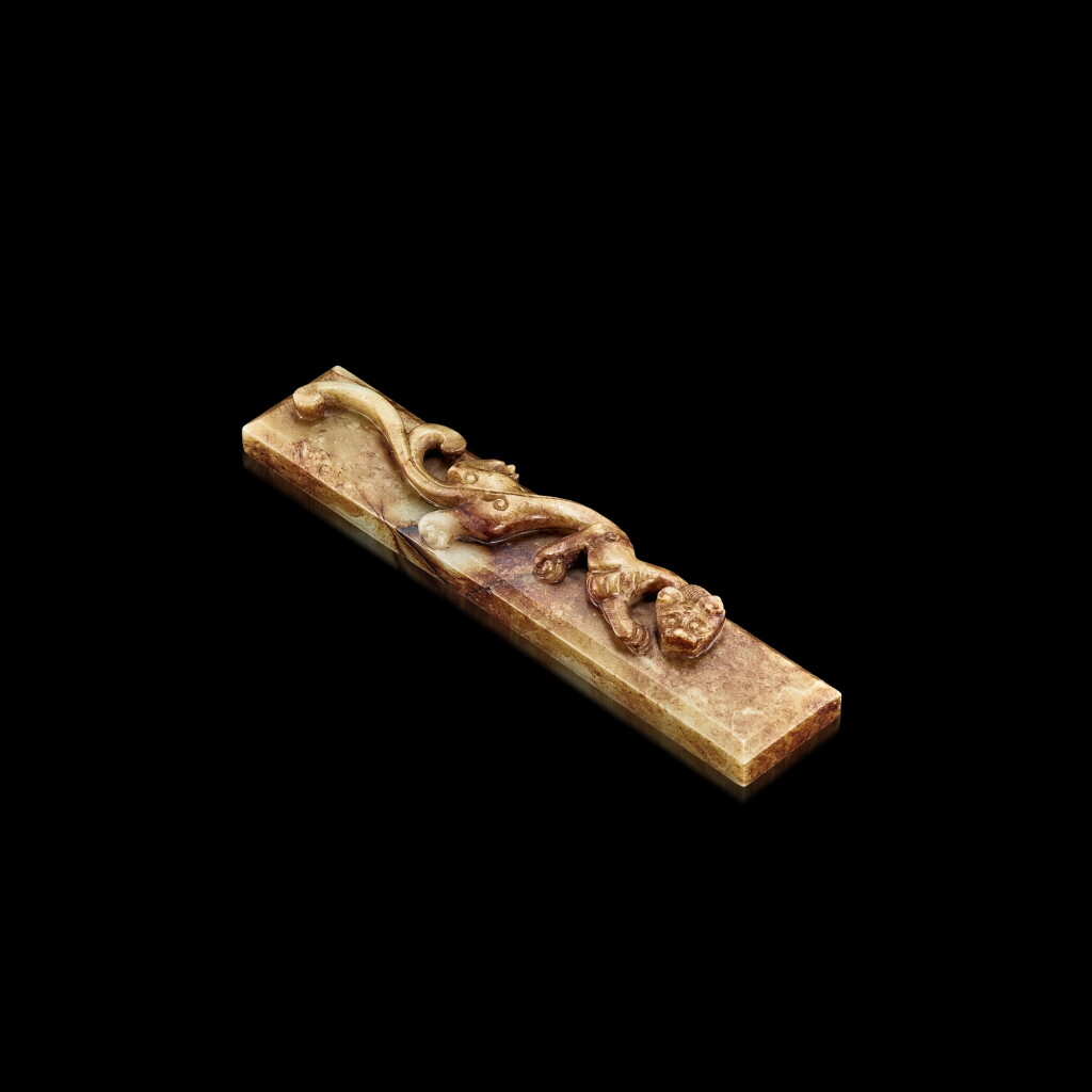 View full screen - View 1 of Lot 3062. A celadon and russet jade 'chilong' scroll weight, Ming dynasty 明 青白玉帶皮螭龍鎮尺.