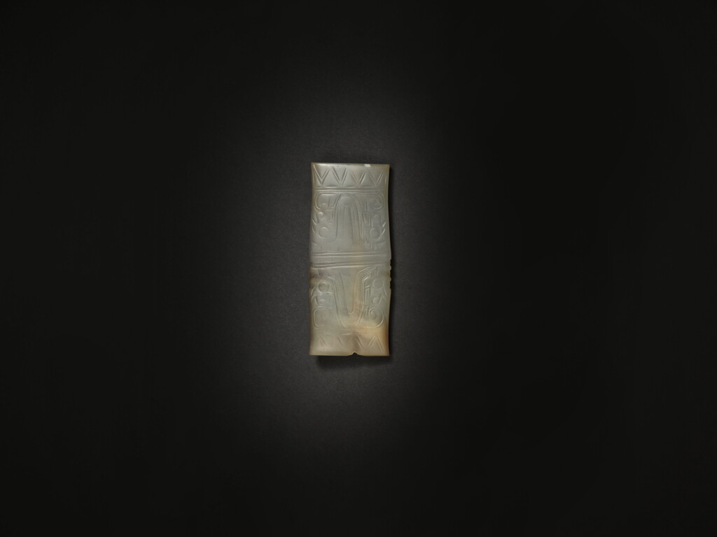 View full screen - View 1 of Lot 256. An archaic celadon jade 'double mask' pendant, Shang / Western Zhou dynasty | 商 / 西周 玉獸面紋飾.