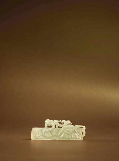 View full screen - View 1 of Lot 79. A carved pale green jade ‘chilong' scabbard slide, Western Han dynasty.