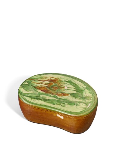 View full screen - View 1 of Lot 702. A sancai-glazed carved 'peony' pillow, Jin dynasty | 金 三彩刻牡丹紋枕.