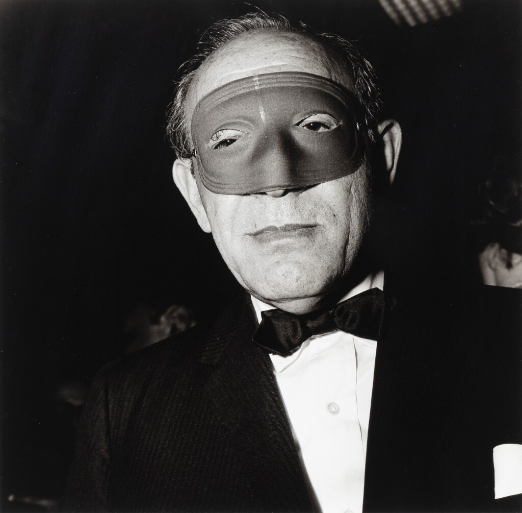 View full screen - View 1 of Lot 8. Masked man at a ball, NYC, 1967.