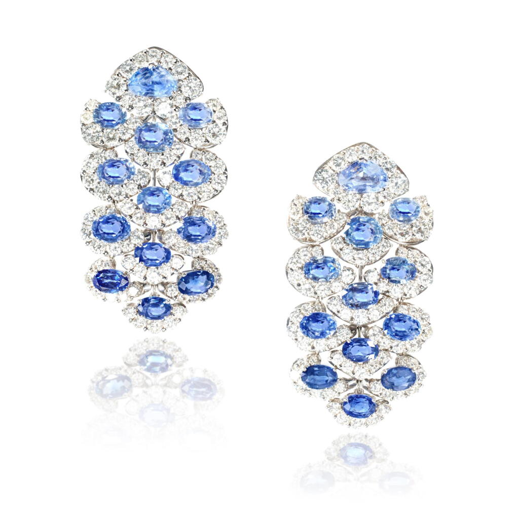 View full screen - View 1 of Lot 536. Pair of sapphire and diamond pendent ear clips, 'Girasole'.