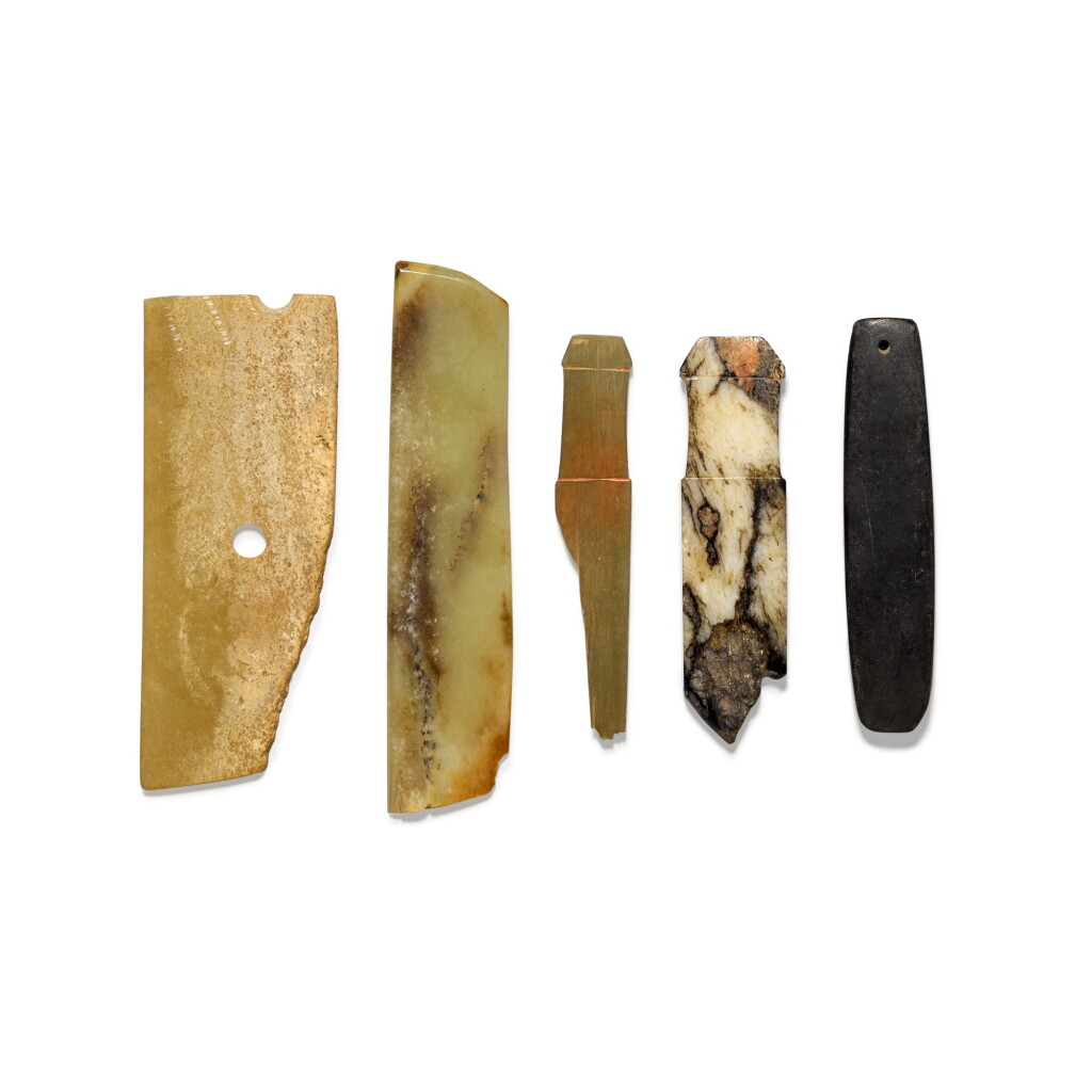 View full screen - View 1 of Lot 14. A group comprising a black stone axe, two jade blade fragments and two jade handles Western Zhou dynasty | 西周 各式玉器 一組五件.