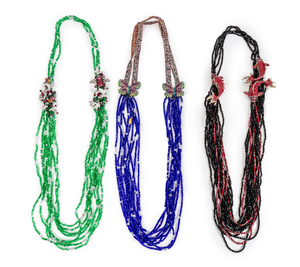 View full screen - View 1 of Lot 132. A set of three multi-strand colored glass pearls, strass and painted metal necklaces, modern.