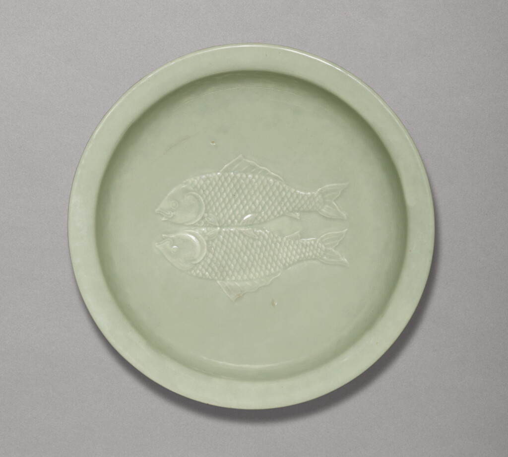 View full screen - View 1 of Lot 31. A RARE CELADON-GLAZED 'TWIN FISH' DISH, QIANLONG IMPRESSED SEAL MARK AND PERIOD | 清乾隆 粉青釉雙魚折沿盤 《大清乾隆年製》款.