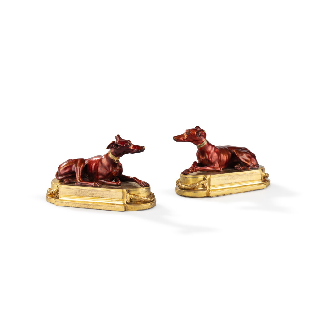View full screen - View 1 of Lot 153. A pair of Louis XVI patinated and gilt-bronze paper weights, circa 1780 | Paire de plaques à papier aux lévriers en bronze patiné et doré d'époque Louis XVI, vers 1780.