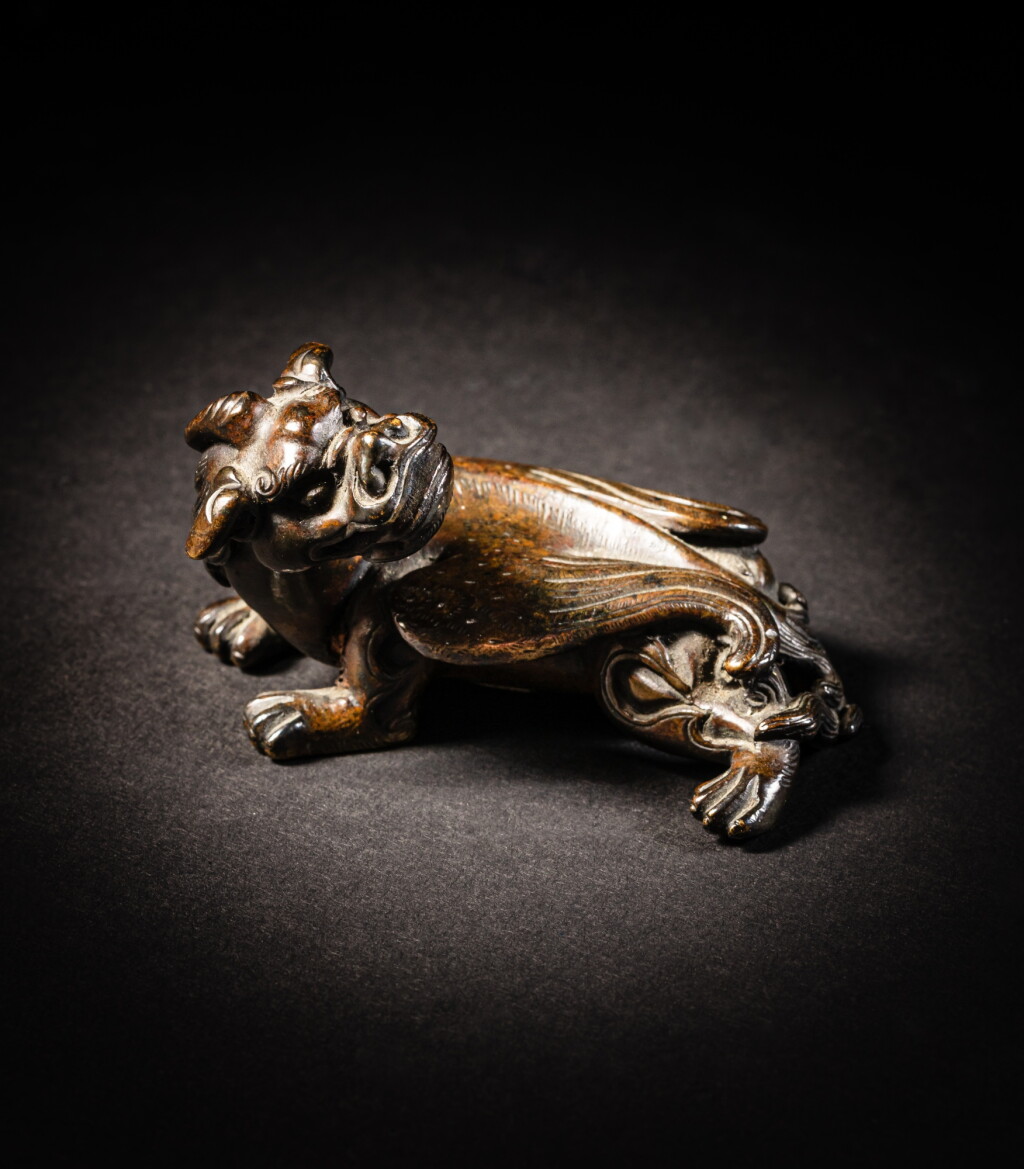View full screen - View 1 of Lot 109. A bronze 'bixie' paperweight, Ming dynasty | 明 銅辟邪鎮紙.