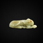 A yellow jade recumbent dog, Ming dynasty or earlier | 明或更早 黃玉雕臥犬