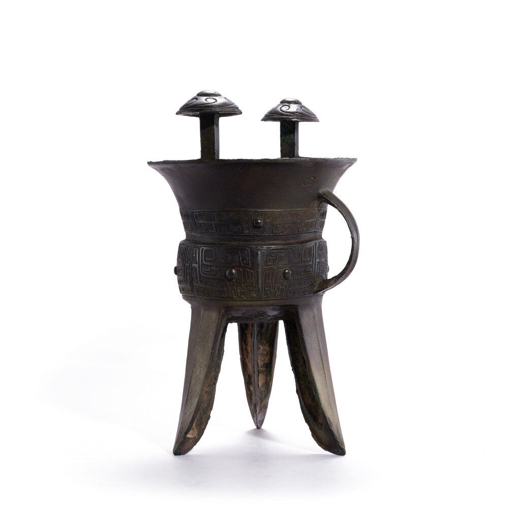 View full screen - View 1 of Lot 703. A bronze 'beast mask' ritual wine vessel, jia | 青銅獸面紋斝.
