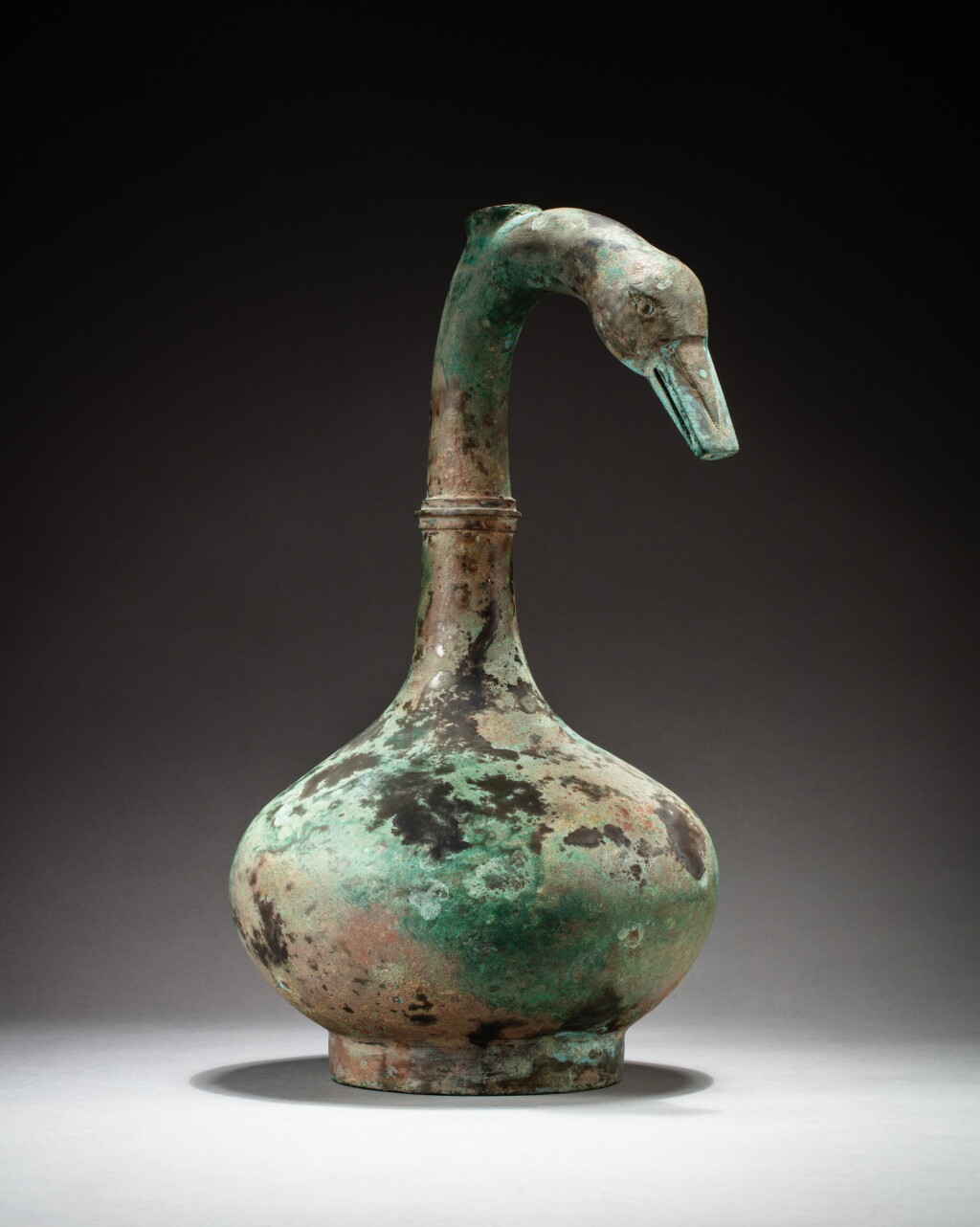 View full screen - View 1 of Lot 26. An archaic bronze 'goose' wine vessel, hu, Han dynasty | 漢 青銅鵝首壺.