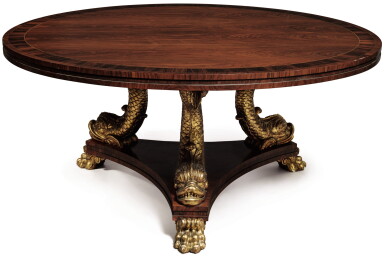 View full screen - View 1 of Lot 593. A LARGE REGENCY STYLE ROSEWOOD CENTER TABLE ON A CARVED AND GILTWOOD DOLPHIN TRIPOD BASE, SECOND HALF 20TH CENTURY.