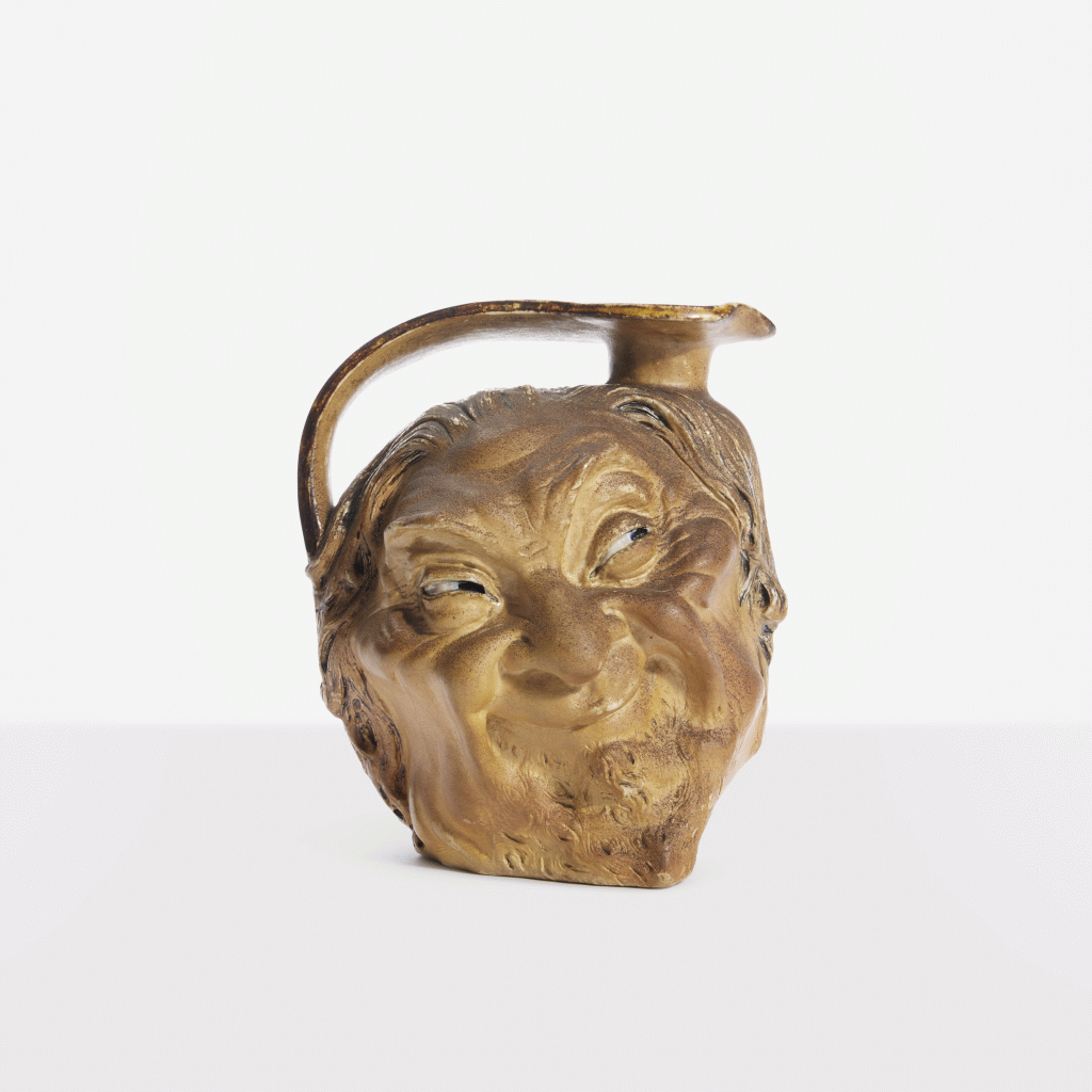 View full screen - View 1 of Lot 127. Double-Sided Face Jug.