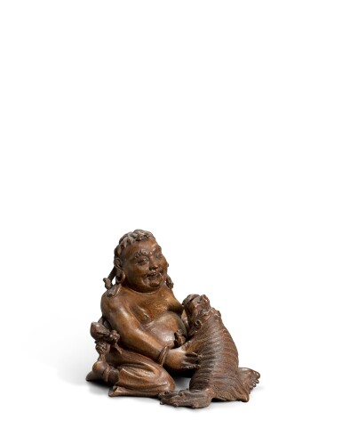View full screen - View 1 of Lot 3903. A carved bamboo-root ‘luohan and lion’ group, Qing dynasty | 清 竹根雕笑獅羅漢坐像.