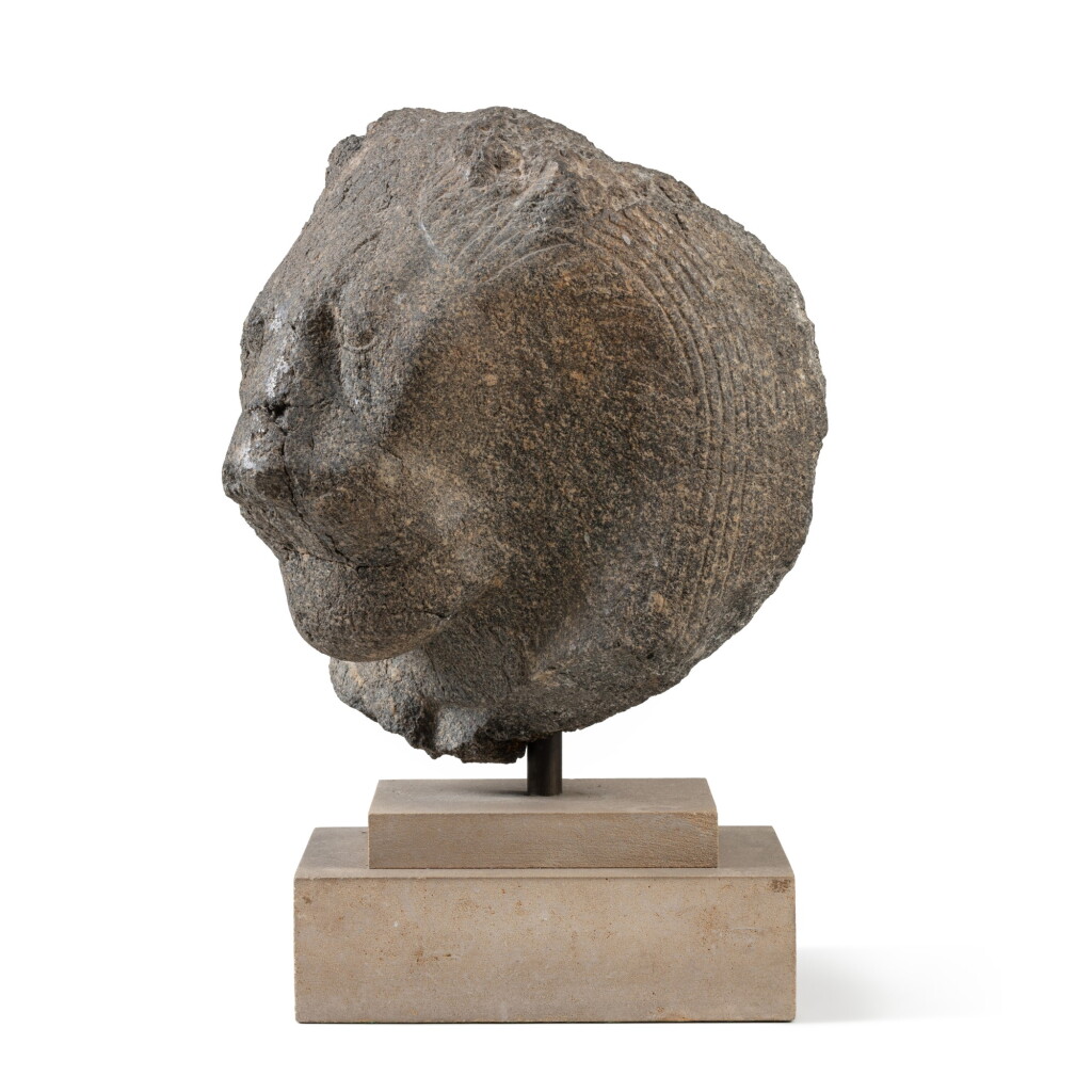 View full screen - View 1 of Lot 28. A Fragmentary Egyptian Diorite or Granite Head of Sekhmet, 18th Dynasty, reign of Amenhotep III, circa 1390-1353 B.C. | Tête fragmentaire de Sekhmet en diorite ou granite, art égyptien, 18e dynastie, règne d'Aménophis III, vers 1390-1353 avant J.-C..
