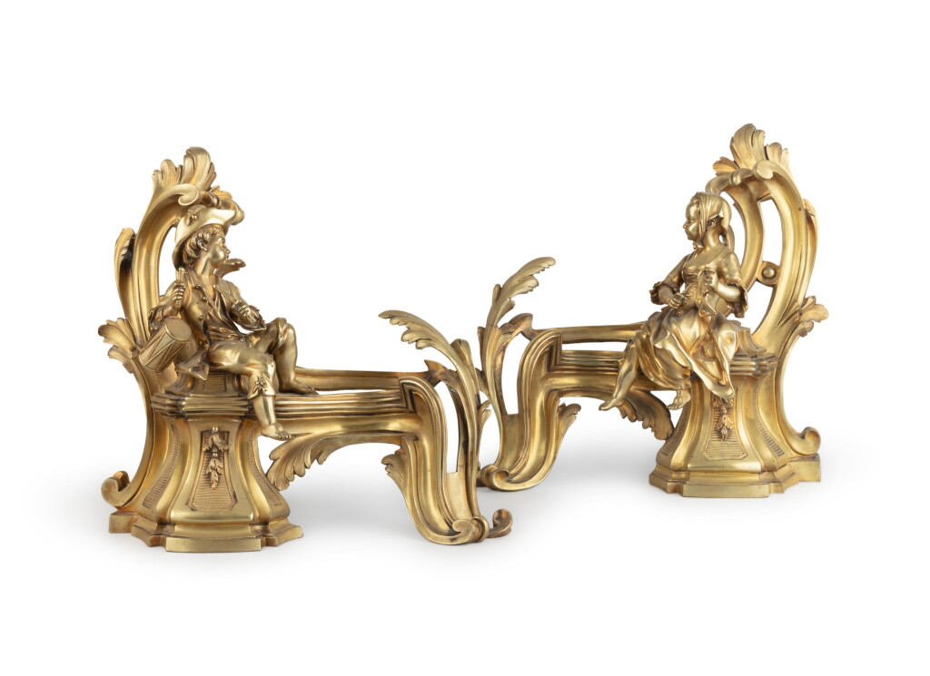 View full screen - View 1 of Lot 58. A pair of late Louis XV gilt-bronze chenets, circa 1765 | Paire de chenets en bronze doré, de la fin de l'époque Louis XV, vers 1765.