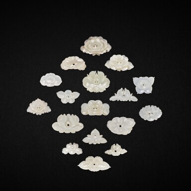 View full screen - View 1 of Lot 3054. A group of twenty seven white and celadon-white jade and an agate 'floral' ornaments, Yuan - Ming dynasty 元至明 白玉及青白玉雕花形飾件一組二十七件及瑪瑙花形飾件一件.