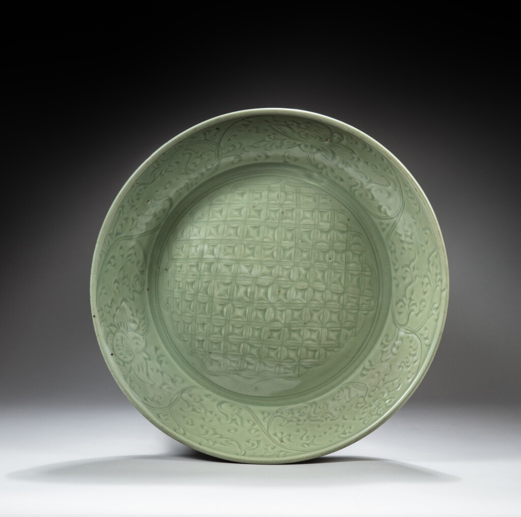 View full screen - View 1 of Lot 108. A large Longquan celadon-glazed 'diaper' dish, Ming dynasty | 明 龍泉窰青釉劃花大盤.