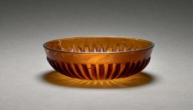 View full screen - View 1 of Lot 212. A ROMAN AMBER-GLASS RIBBED BOWL, CIRCA LATE 1ST CENTURY B.C./ MID 1ST CENTURY A.D..
