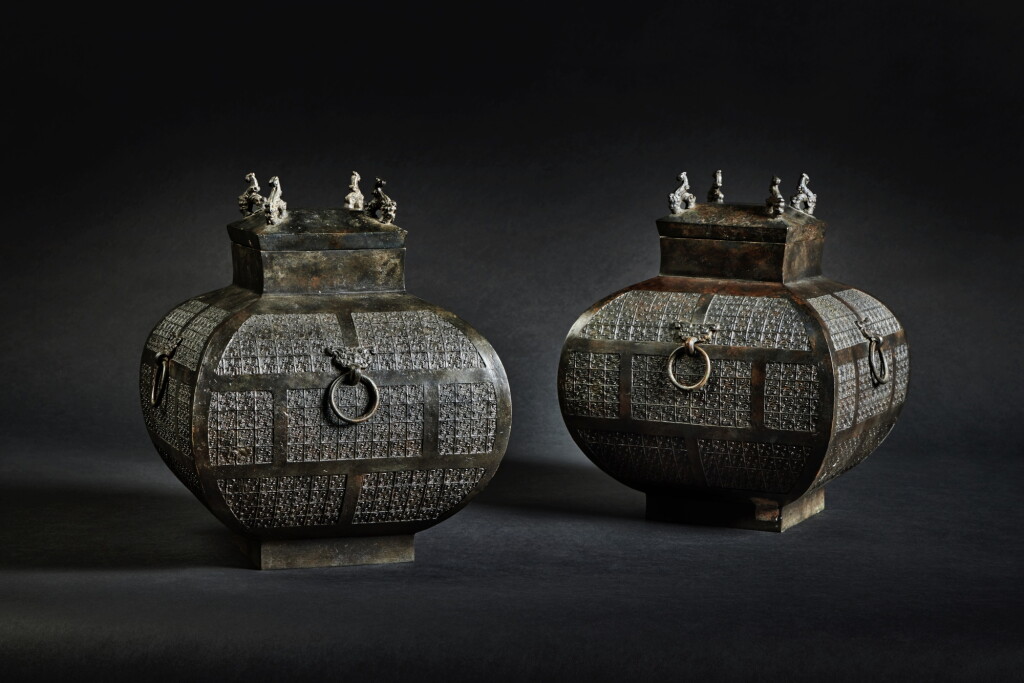 View full screen - View 1 of Lot 169. A pair of archaic bronze ritual wine vessels and covers (Fanghu), Eastern Zhou dynasty, Warring States period.