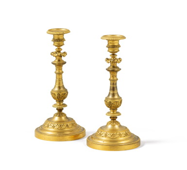 View full screen - View 1 of Lot 34. A pair of Louis XVI gilt-bronze candlesticks, probably by the bronzier Pierre-Auguste Forestier, after a design by Jean-Démosthène Dugourc (1749-1825) | Paire de bougeoirs en bronze doré d’époque Louis XVI, probablement par Pierre-Auguste Forestier sur un dessin de Jean-Démosthène Dugourc (1749-1825.