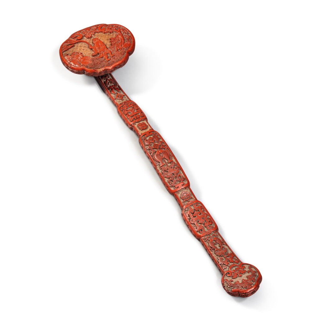 View full screen - View 1 of Lot 1314. A carved cinnabar lacquer ruyi scepter, Qing dynasty, Qianlong period | 清乾隆 剔紅鉄拐李萬福圖如意.